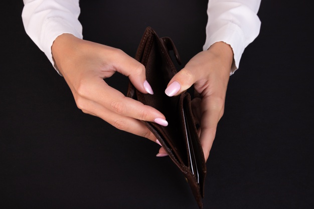 business-womans-hand-holds-empty-wallet-black-background_297535-511